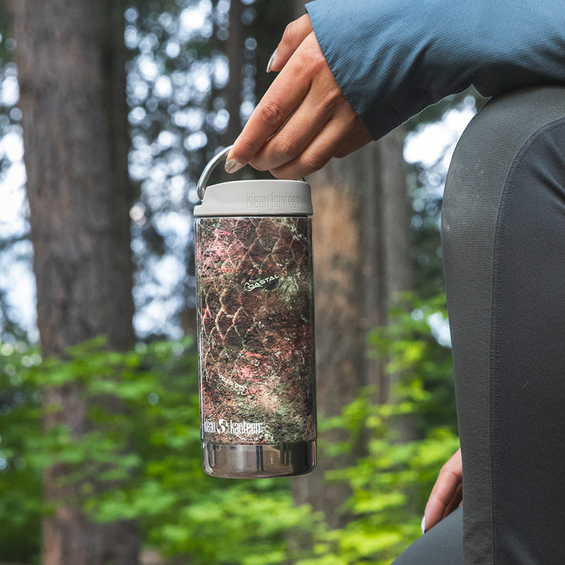 12oz-tkwide-with-twist-cap-mossy-oak-x3 12oz_tumbler_mossyoak_rainbowtrout_hand_closeup_square.jpg